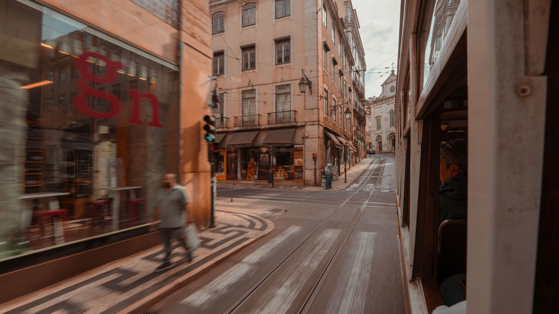 Experience Lisbon's vibrant street life from a tram perspective, showcasing lively urban scenes.