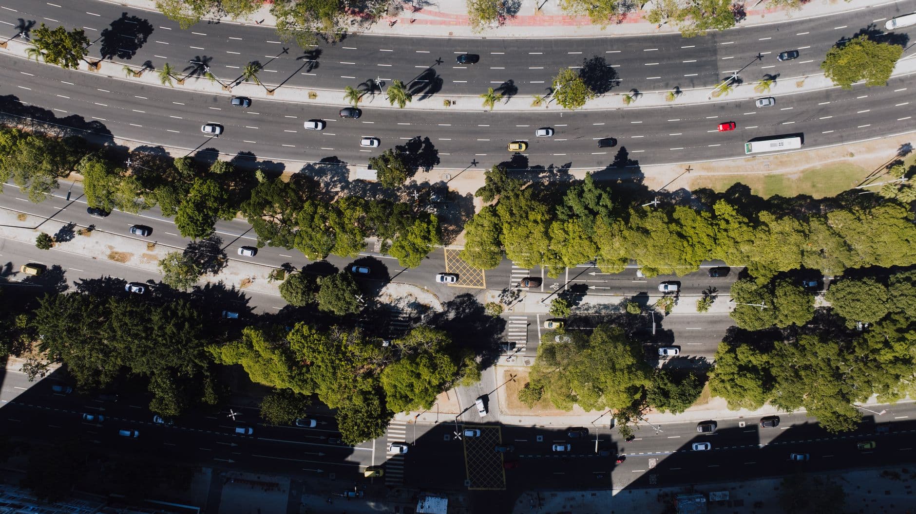 A birds-eye view of busy streets and lush greenery in Rio de Janeiro, Brazil.