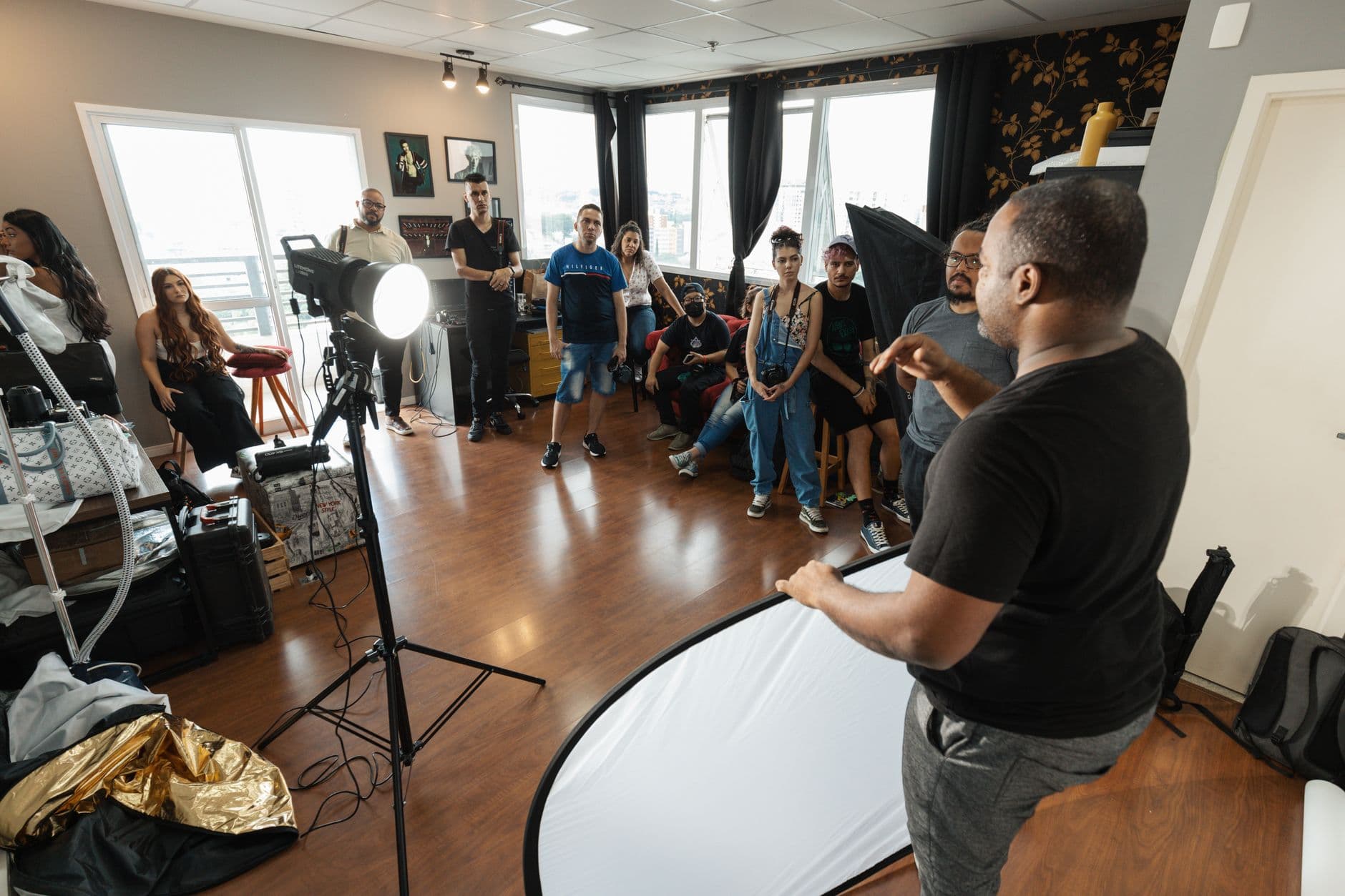 A lively photography workshop featuring a diverse group of participants and professional setup.