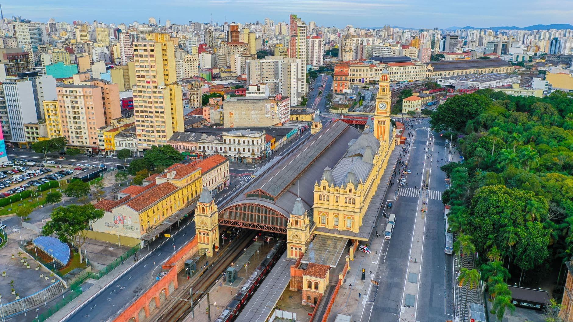 Stunning aerial shot of São Paulo's Luz Station and urban skyline on a clear day.